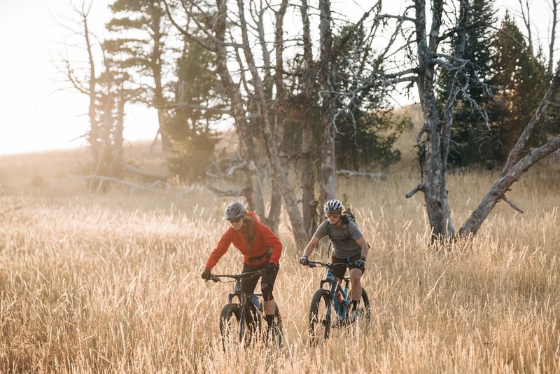 Mountain bikers in the fields near the Big Belt Hut.